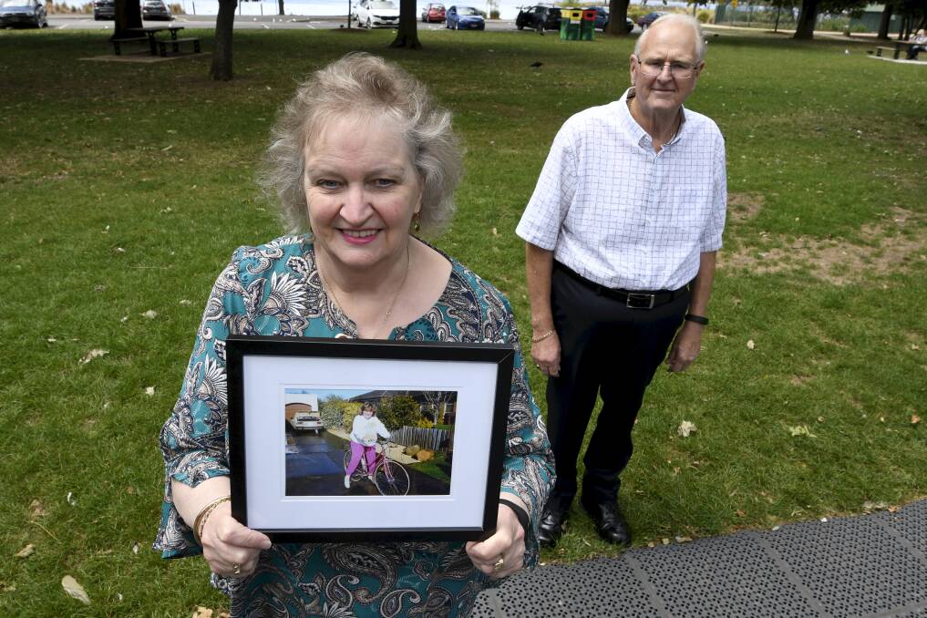 MEMORY: Gail and Greg Elsey by the lake with a picture of Fiona, who liked to bike ride.