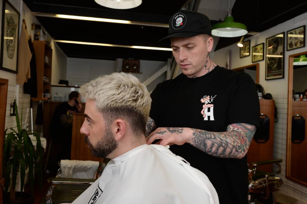 OPEN: Barber Jimmy Morrison says it is a good thing if people feel comfortable to talk in his chair but personally, self-care is vital to ensuring the burden does not follow him home. Picture: Kate Healy
