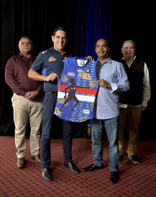 Design:  Adrian Rigney, Brett Goodes, Peter Shane Rotumah and Thomas Marks with the Western Bulldogs' Indigenous round jumper. Photo: Dylan Burns