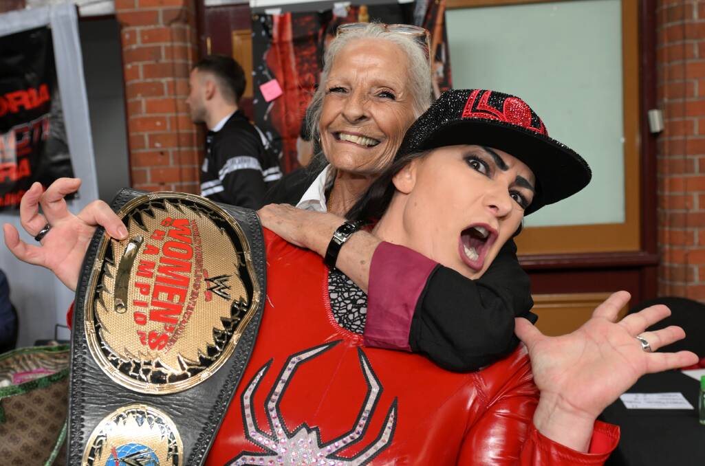 Seventy-year-old wrestling fan Vee enjoys the chance to put a headlock on two-time WWE women's champion Lisa Marie Varon (who wrestled under the name Victoria) at Ballarat Mining Excahnge on April 12, 2024. Picture by Lachlan Bence