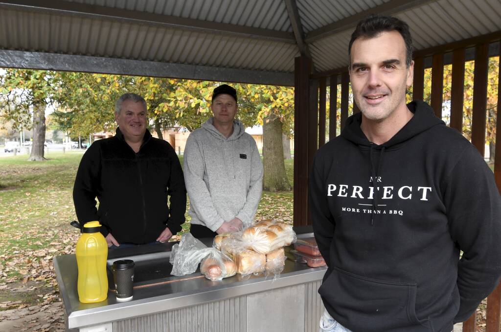 UP FOR A CHAT: Ballarat's Mr Perfect team Sean Schwager Stephen Nurnane, Justin Thompson prepare to fire up the barbecue by Lake Wendouree on Sunday. Picture: Lachlan Bence