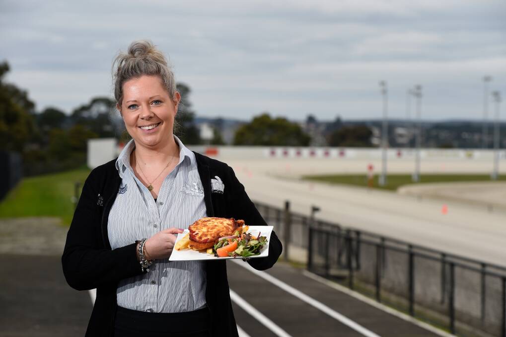 SUPPORT: Flying Horse Bistro venue manager Rebecca Bell serves up a parma to help farmers in a Ballarat and District Trotting Club fundraising campaign. Picture: Adam Trafford