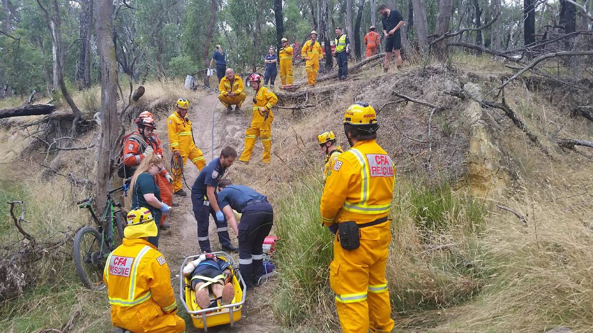 SCENE: Paramedics and fire rescue workers use a high-angle rope to retrieve injured mountain bike rider Kyle Frew from dense bushland in Durham Lead on Saturday. Picture: Brett Domaschenz