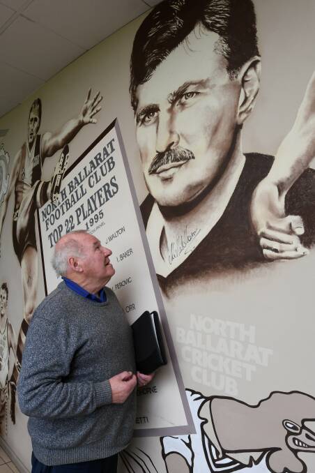 HONOUR ROLL: North Ballarat historian Digger Roberts before the club mural featuring hall of famers like Michael Malthouse, a Wendouree West junior who was recruited to the AFL from North Ballarat. Picture: Lachlan Bence