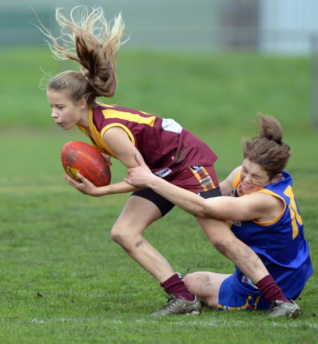 TAKING OFF: Isabella Robson (Redan) and Taylah Markham (Sebastopol) are in action for Ballarat's fast-growing female football ranks. Picture: Kate Healy