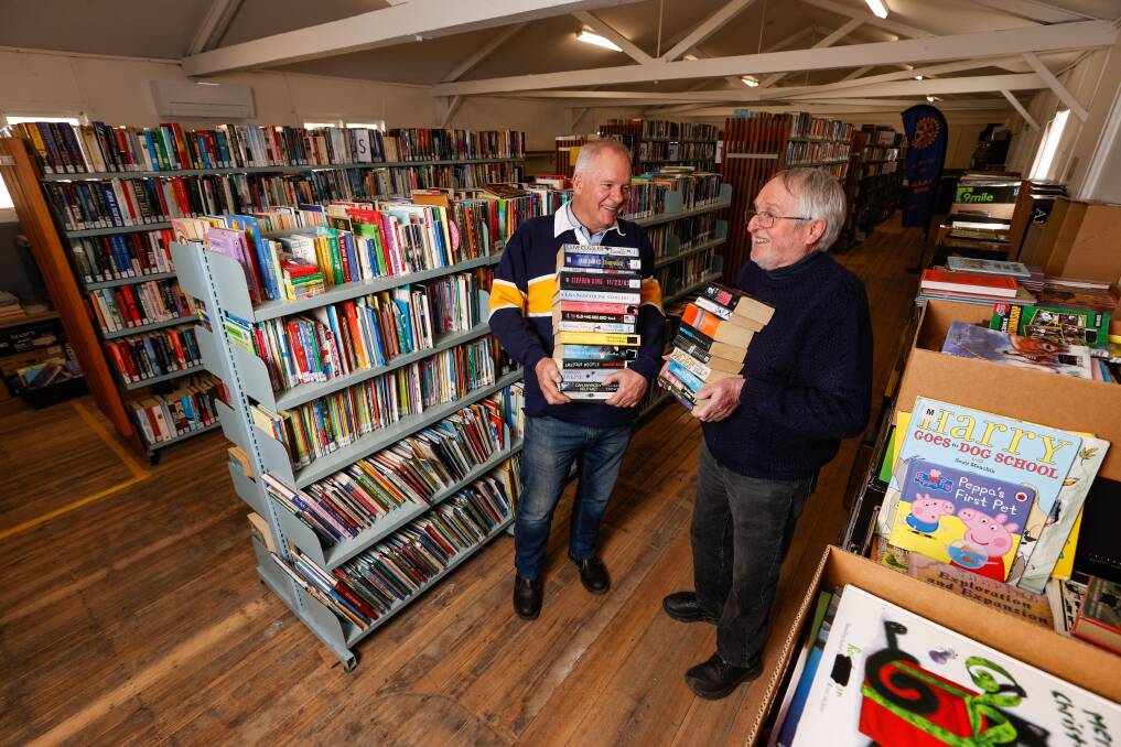 STACKING UP: Rotary Club of Ballarat East's Phil Mann and David Stokes prepares to host its first book sale in three years. Picture: Luke Hemer