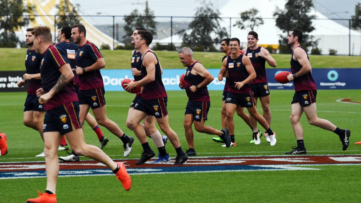 Brisbane Lions coach Chris Fagan gets in the Ballarat spirit with his players at training on Friday evening. Picture: Kate Healy
