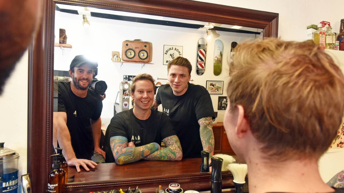 TEAM APPROACH: Jimmy Morrison teams with Zambrero and headspace's Andy Penny for men's support program Arms and Armour in his barber shop Musket and bayonet. 