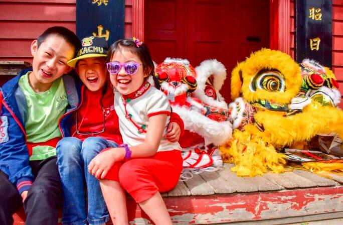 CELEBRATIONS: Louis, Jayden and Adeline wait for the lions to come to life for Chinese New Year at the Chinese Temple in Sovereign Hill. Picture: Brendan McCarthy