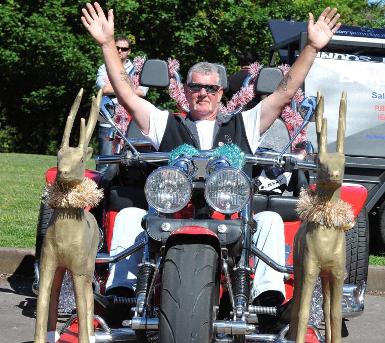 CHEER: Motorcyclist Mitch Walton and his reindeer-led sleigh get ready to roll Picture: Lachlan Bence