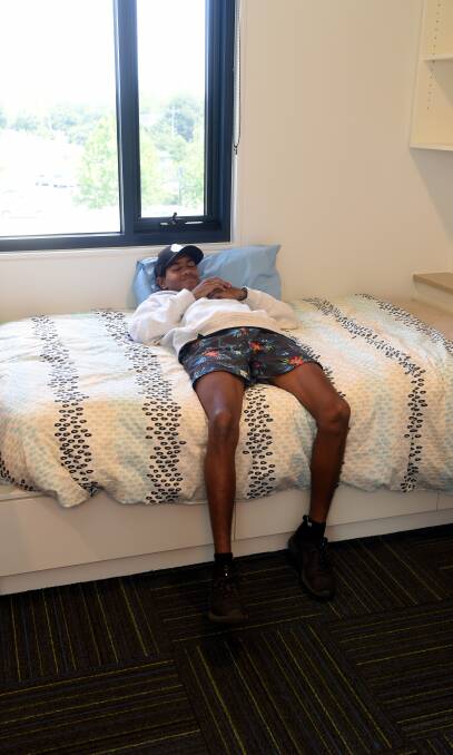 RELAXED: Mick Derrick makes himself right at home amid the excited chaos of moving day.