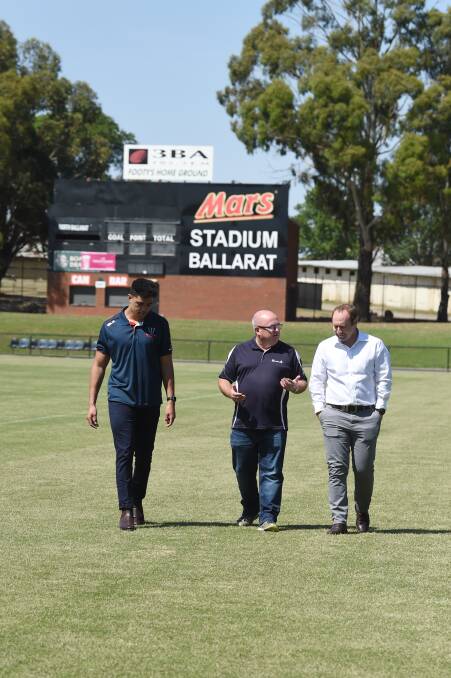 REBEL YELL: Melbourne Rebel Semisi Tupou, City of Ballarat councillor Des Hudson and Rebels general manager Nick Ryan walk on the Rebels' Mars turf on Thursday. Picture: Kate Healy
