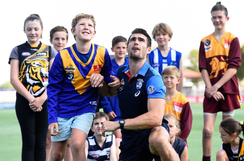 PACK LEADER: Western Bulldogs captain Easton Wood with Fraser Sutton and fellow Ballarat Football League juniors promote responsible gambling at Mars Stadium last year. Picture: Adam Trafford