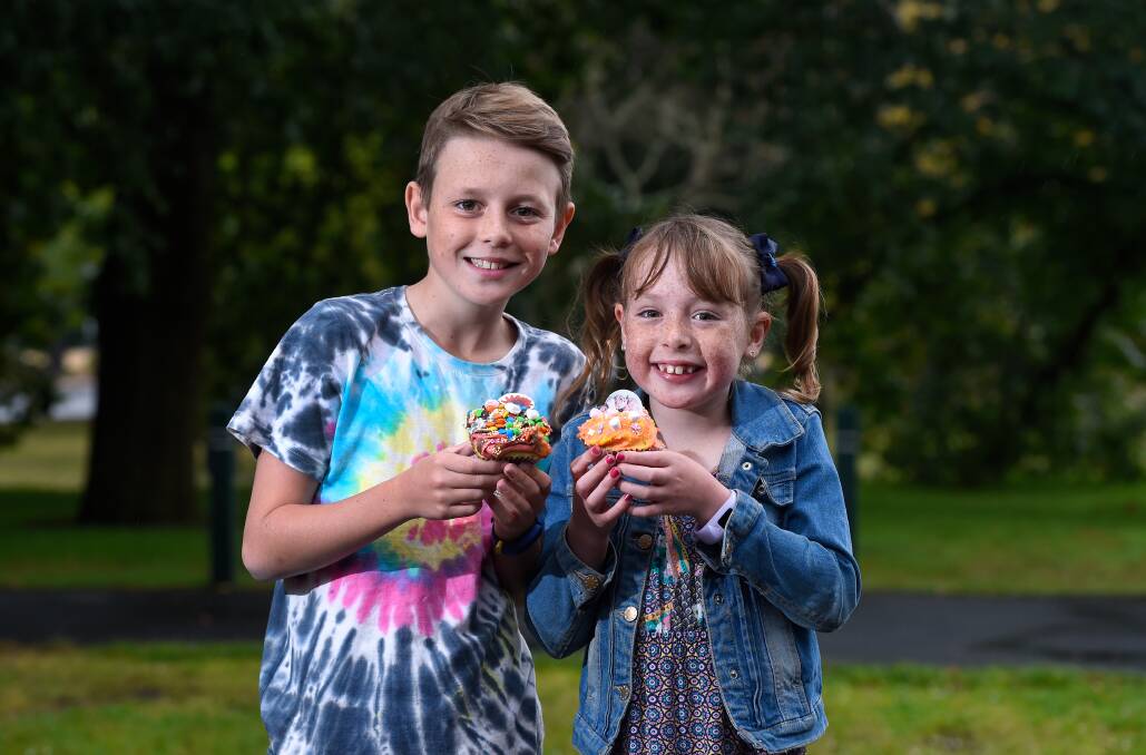 SWIRLING DELIGHT: Siblings Noah and Mia Jeffrey are ready to bite into their colourful creations from a new-look, low-key Begonia festival. Picture: Adam Trafford