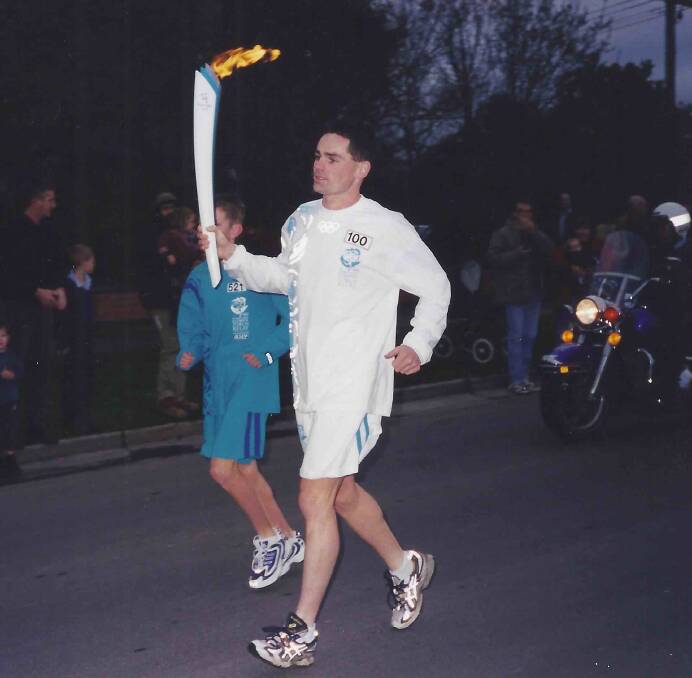 FLASHBACK: Stephen McMahon proudly carried the Olympic torch from Victoria Street into Stawell Street on a packed route. Picture: courtesy of Stephen McMahon
