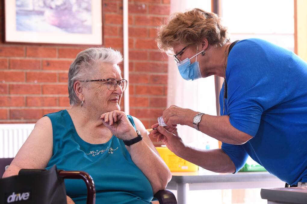 READY: James Thomas Court resident Joan Armstrong receives her vaccine from Ballarat Health Services registered nurse and vaccine specialist Carolyn Allen on Monday. Picture: Adam Trafford