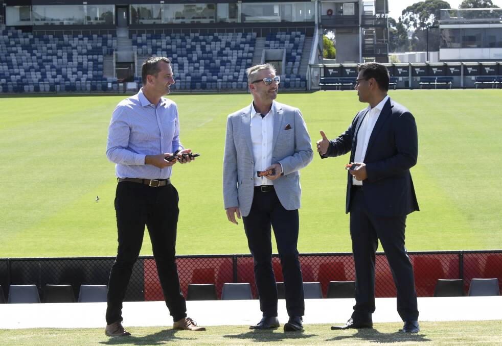 DEAL SWEETENER: City of Ballarat mayor Daniel Moloney, Mars Wrigley general manager Andrew Leakey and Western Bulldogs chief executive Ameet Bains talk over a chocolate at Mars Stadium on Monday. Picture: Lachlan Bence