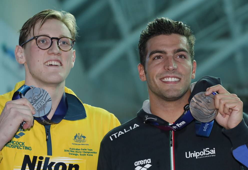 STATEMENT: Australia's Mack Horton would, however, hold his silver medal for a photo with bronze medalist Italy's Gabriele Detti. Picture: AP