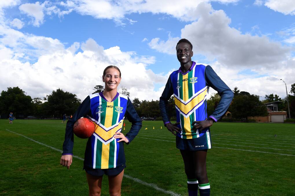 MAKING A MARK: Loreto's Charlee Hill and St Patrick's Deng Lual stand united for the Respect Cup in soecial blended football guernseys. Picture: Adam Trafford