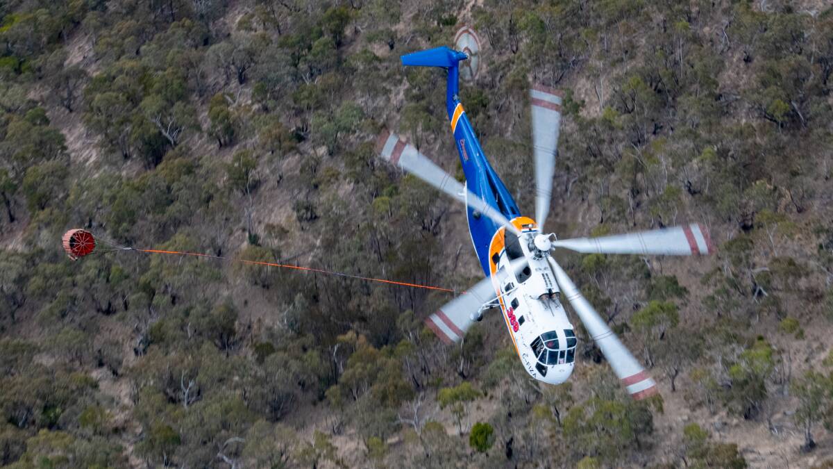 SUPPORT: Canadian fire fighting helicopter in action working on Victorian bushfires this summer. The chopper is en route to Ballarat. Picture: Ned Dawson