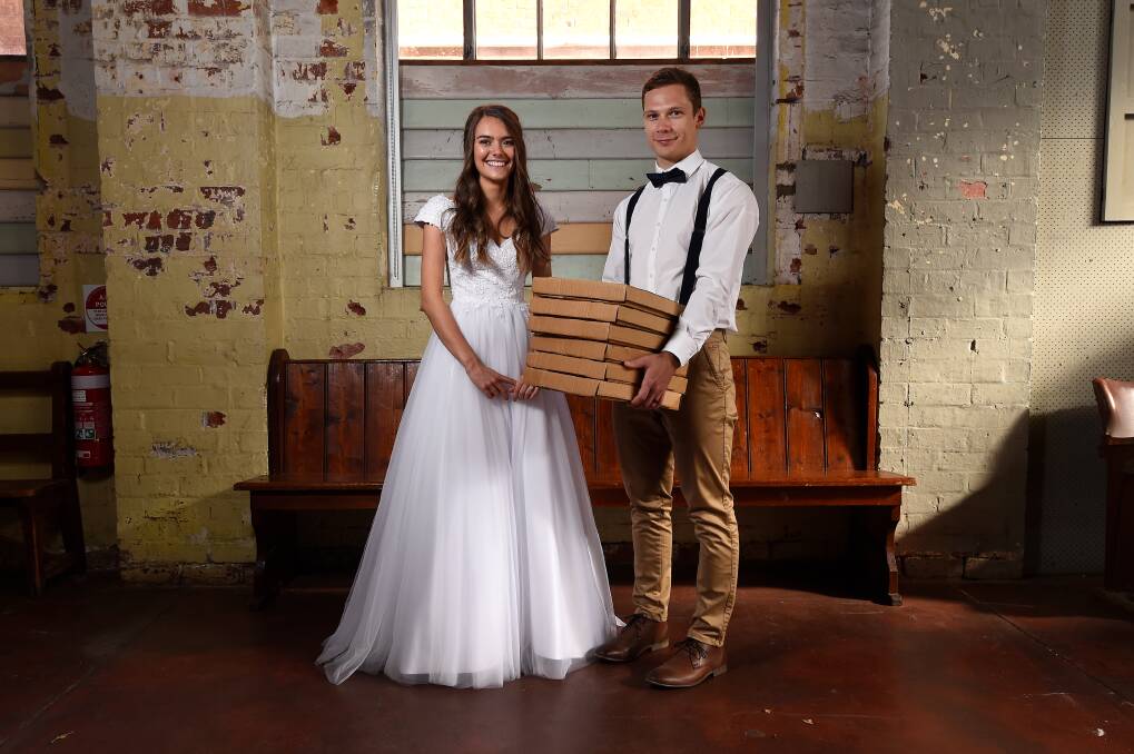 WEDDED TWIST: Newlyweds Jane and James Edwards pick up pizzas from The Forge to celebrate their wedding day with immediate family after a small ceremony. Picture: Adam Trafford