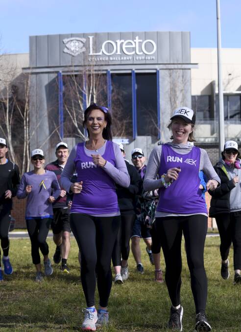 READY: Abby McGrath and Loreto teacher Kelli Ibbotson lead off a those ready to move for the school's annual 4EK lap of the lake on Thursday. Picture: Lachlan Bence