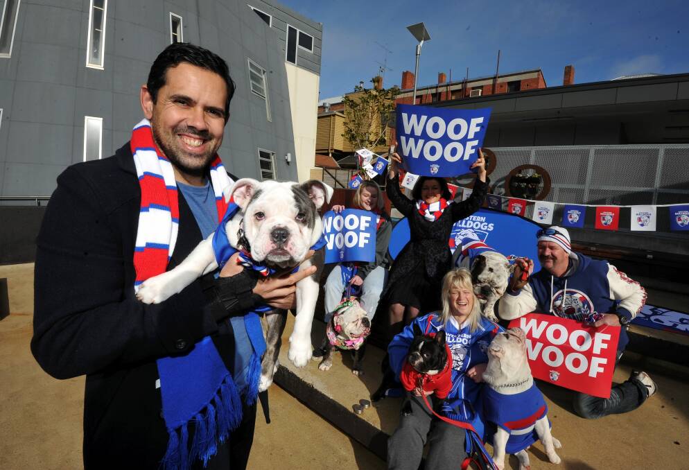 PUPPY LOVE: Western Bulldogs' engagement manager Brett Goodes meets official club mascot Caesar's half-sister ahead of the big gathering of the pack across Ballarat. Picture: Lachlan Bence