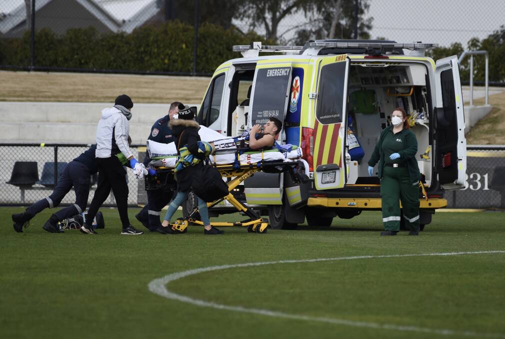 SCENE: Darley's Adam Azzopardi is stretchered from the field by ambulance with a likely broken ankle at Mars Stadium on Saturday.