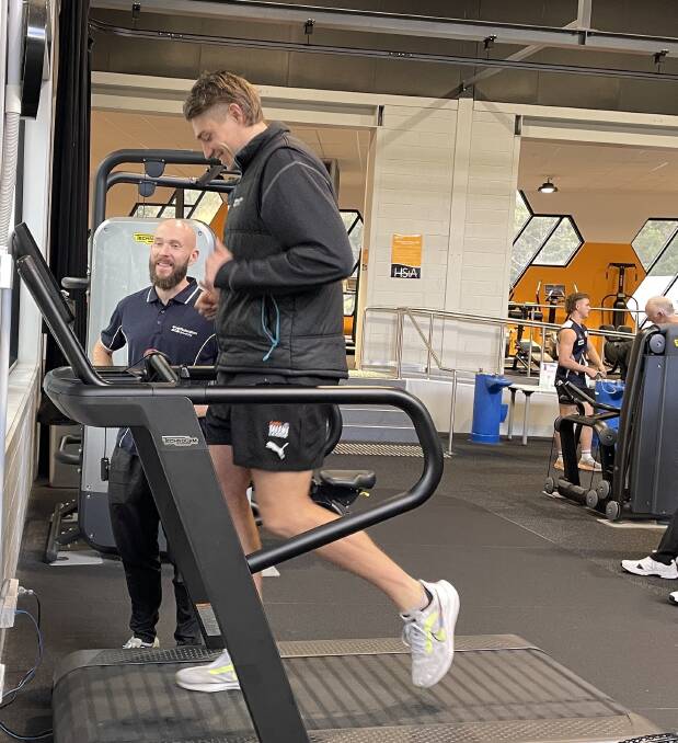 Federation University exercise and sports scientist Ryan Worn, overlooking a runner in the Mount Helen gym, says now is a great time to practice for race day, including how to fuel. Picture by Melanie Whelan
