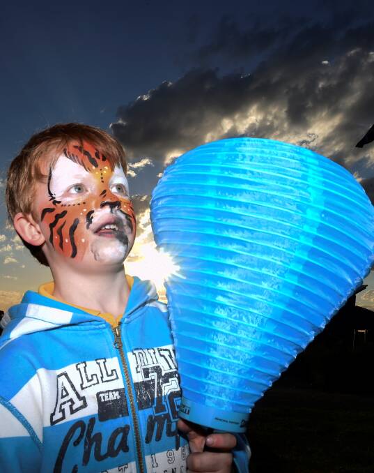 HOPE: Youngster Rick Barber holds a blue lantern to show he cares in last year's Ballarat Light the Night event. Picture: Lachlan Bence