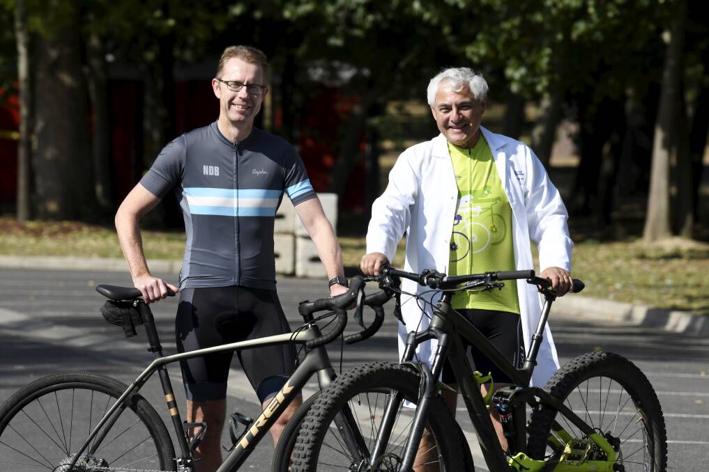 PURPOSE: City of Ballarat chief executive officer Evan King warms up for his road ride with Fiona Elsey Cancer Research Institute honourary director George Kannourakis. Picture: Lachlan Bence