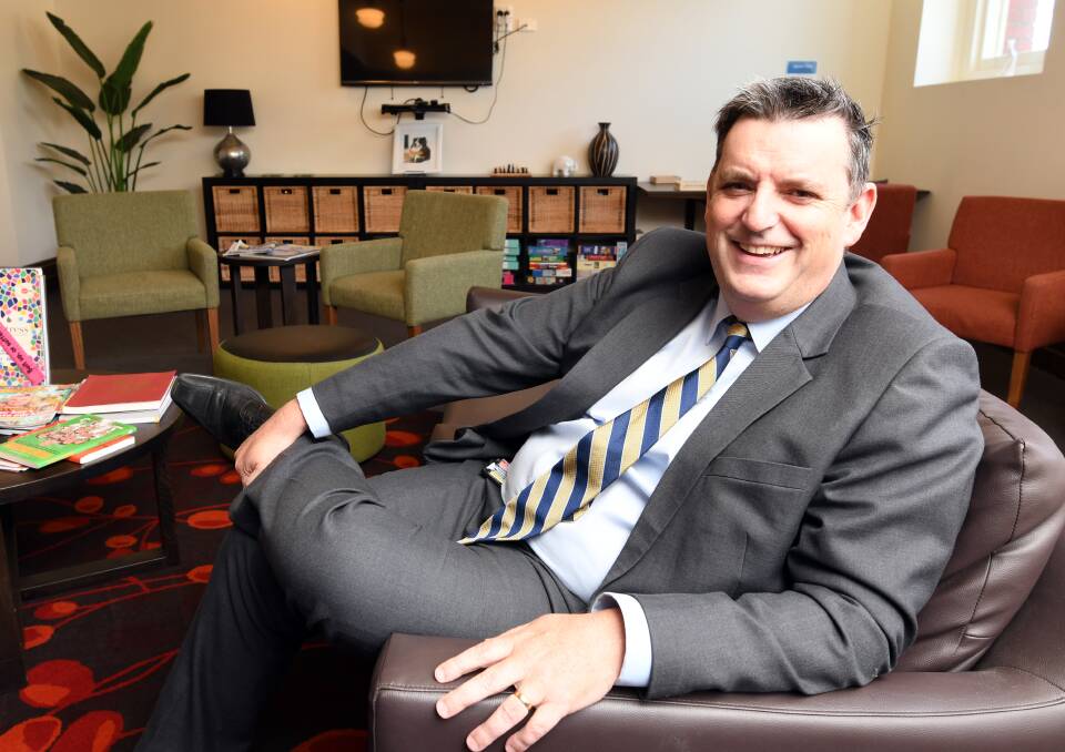 Grampians Health chief executive Dale Fraser enjoys a seat before the fireplace in the Ballarat cancer wellness centre. Picture by Lachlan Bence