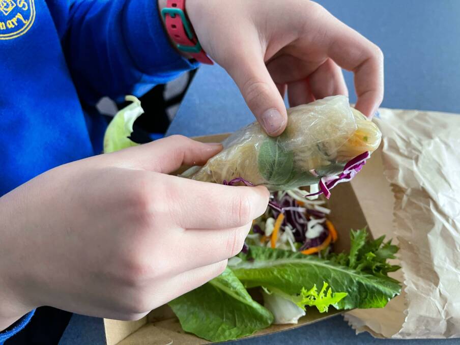 NEW ORDER: A Daylesford Primary School pupil gets ready to tuck into a rice paper roll under the Healthy Lunches project. Picture: Healthy Lunch Kitchen