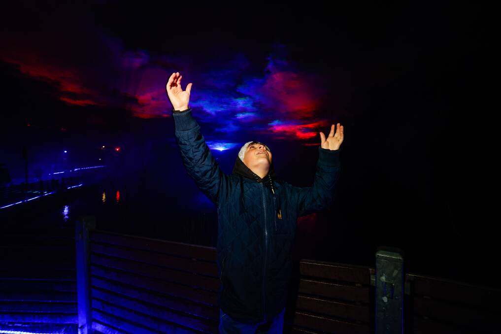 Oliver Howard enjoys the nighttime spectacular Borealis on the Lake in Daylesford last year. Picture by Luke Hemer