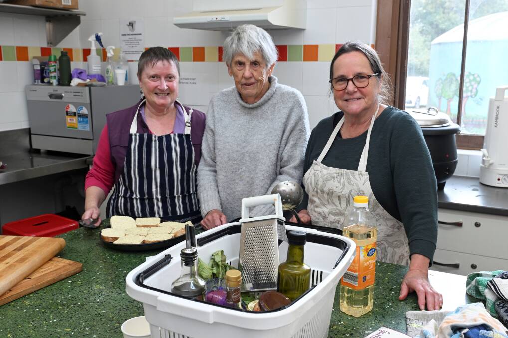 In the kitchen, Sandy Jennings, Mauree Hazelton, Jenni Sewell prepare lunch for an unknown number of guests, but demand in Creswick is growing. Picture by Lachlan Bence