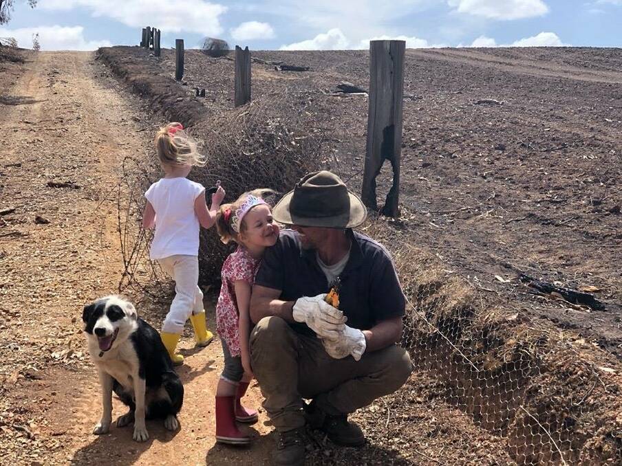 LOVE: Fourth generation Lexton farmer Rod McErvale with daughters Isla and Maddison in the wake of the 2019 Lexton fires is the winning photos for St John of God Raphael Services men's mental health week. Picture: Rebecca McErvale