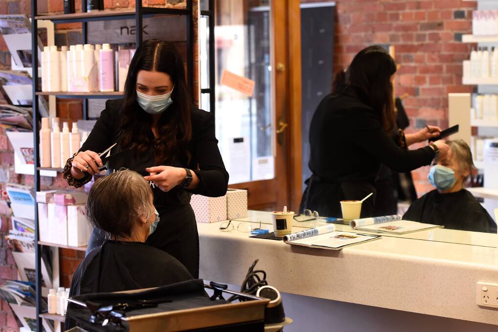 NEW LOOK: Ivy Hairdressing owner Aleesa Campbell and client say they feel more comfortable 'masking up' for an appointment in Ballarat amid the pandemic. Picture: Adam Trafford