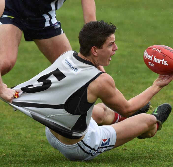 CRUNCH TIME: All-Australian Jarrod Berry feels the pressure in a return to TAC Cup action against a tenacious Geelong Falcons in heavy rain on Sunday. Picture: Lachlan Bence