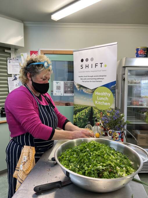 FOCUS: Healthy Lunch Kitchen cook Sallie Harvey using greens from local farms in Hepburn Shire. Picture: Healthy Lunch Kitchen