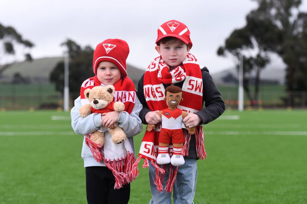 TOUGH BREAK: Mia, age four, and Edwin, age six, are sad to learn their Swans heroes are no longer coming to play AFL at Mars Stadium due to the coronavirus restrictions. Picture: Adam Trafford