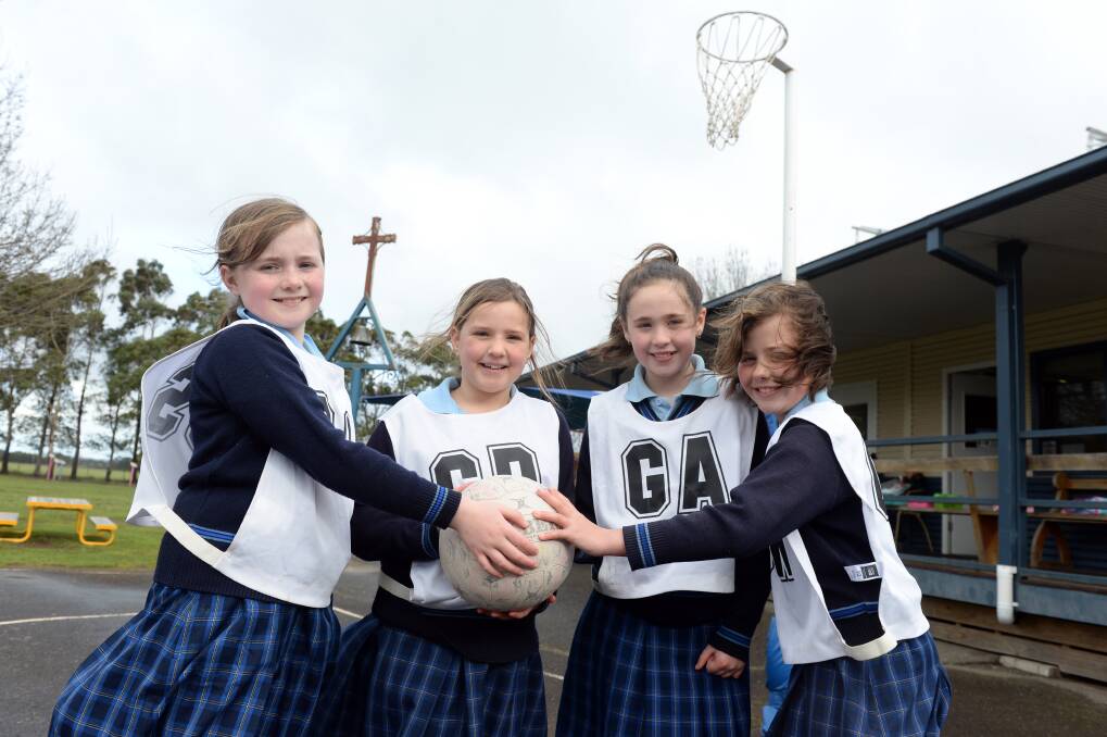 TOGETHER: St Brendan's Primary School netballers Sophie, Sienna, Emma and Bonnie can hardly wait to get back on court at Llanberris. Picture: Kate Healy