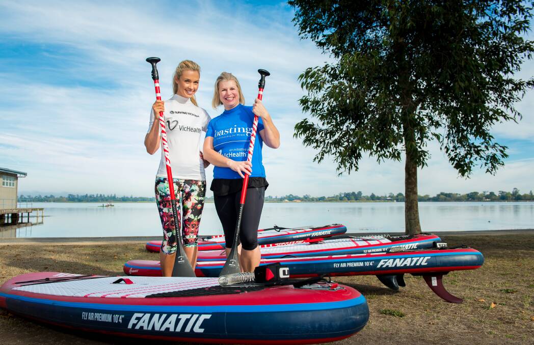 COASTING: Television personality Brodie Harper gets ready to do some stand-up paddleboarding with Ballarat's Kylie Wilson for the first session on Lake Wendouree three years ago. Picture: Dylan Burns