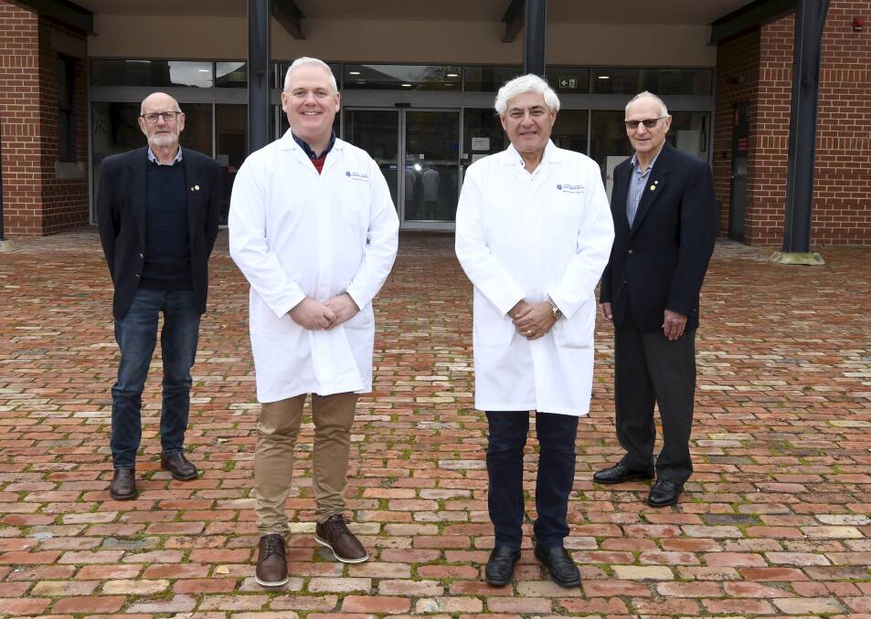 Rotarians Max Fry and Barry Stokes offer support to Fiona Elsey Cancer Research Institute bowel cancer lead Jason Kelly and honourary director Professor George Kannourakis. Picture by Lachlan Bence
