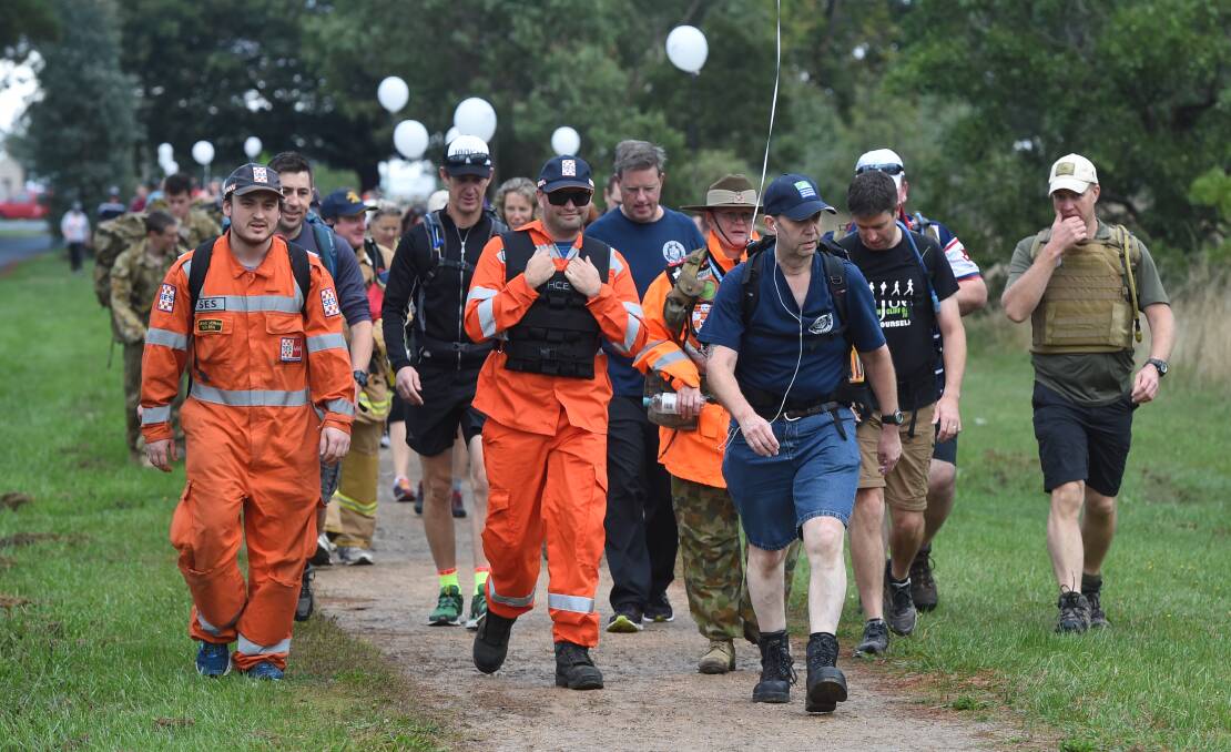 State Emergency Service crews step out in uniform for Walk Off the War Within about Victoria Park in 2017. 