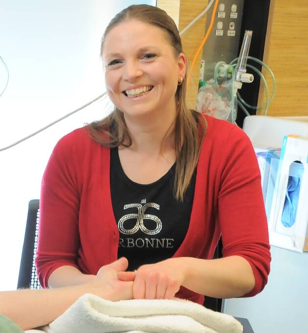 SPECIAL TOUCH: Dry July efforts introduced Virginia Rogers with free hand massages for chemotherapy patients in Ballarat Regional Cancer Centre this year.