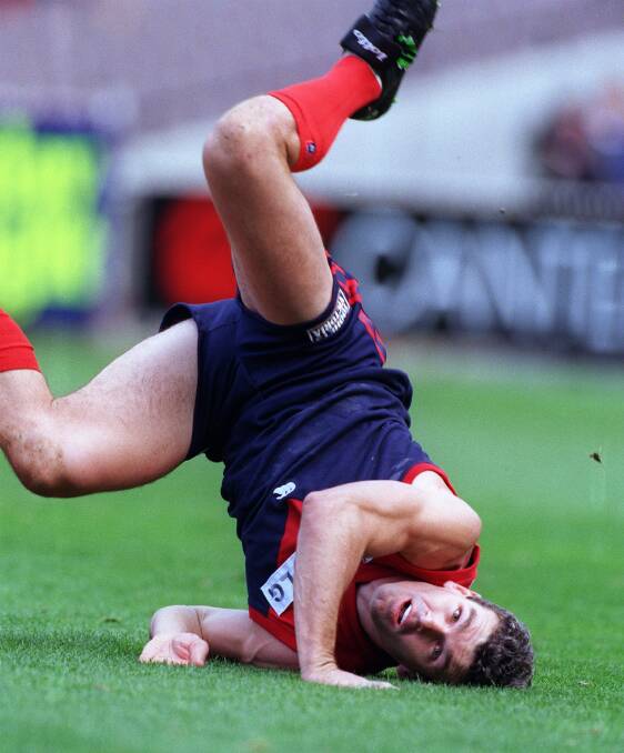 CRASH LAND: High-flying Melbourne, and later Newlyn, footballer Shaun Smith hits the ground after a mark attempt in 1998. Smith is donating his brain to research and is among players threatening to sue the AFL. Picture: The Age