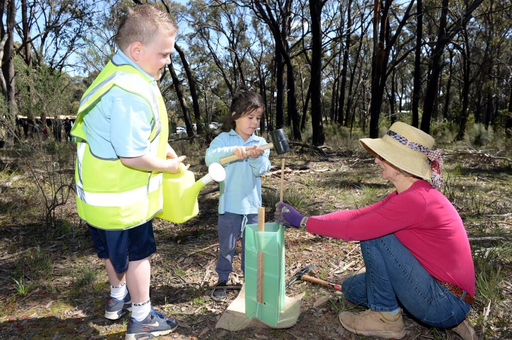 GREENER APPROACH: Chev (grade two) and prep Teliyah work with Karen in Woowookarung Regional Park along the new dementia trail. Picture: Kate Healy