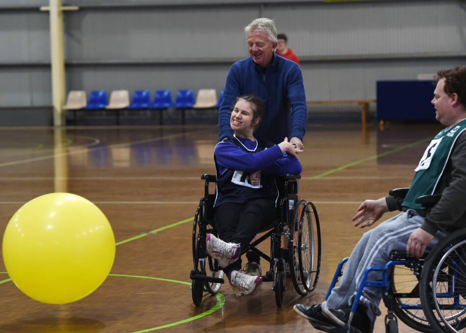 ACTION: Rebecca, wheeled into ruck work by Michael, enjoys trying Balloon Football for the first time in Ballarat for a trial day. Picture: Kate Healy