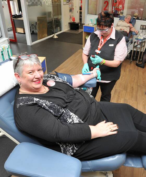 HERO: City of Ballarat chief executive officer Justine Linley under the watchful eyes of  Blood Bank nurse Lou Hack. Picture: Lachlan Bence