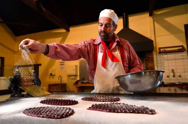 PREPARATION: Sovereign Hill confectioner Ben Bignell has batches of raspberry drops at the ready from his first day back in Brown's Confectionery shop. Picture: Adam Trafford